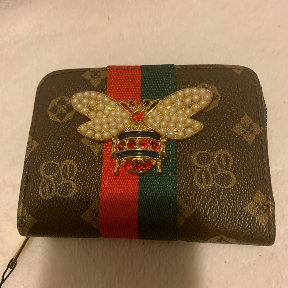 Inspired wallet with a bee on the front.